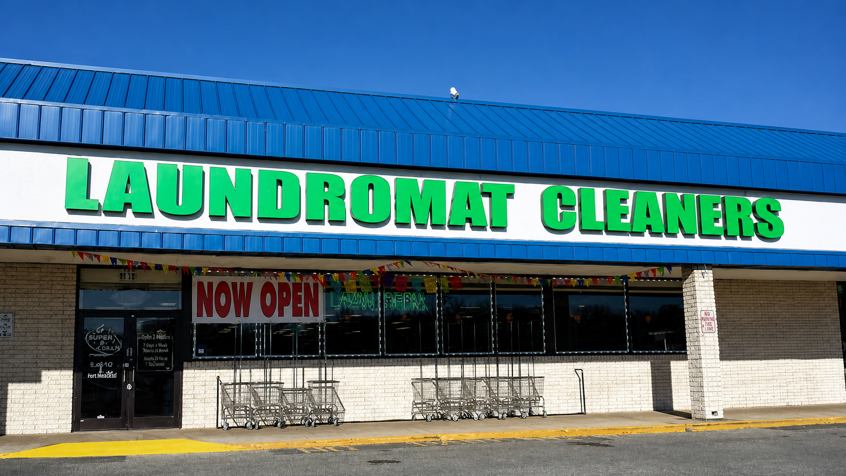 Super Clean Laundromat storefront with blue roof and green Laundromat Cleaners sign
